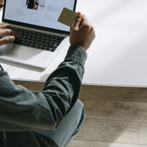 a man with a laptop paying for online services